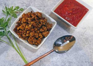 Sausage flavored tempeh and pizza sauce by Roaring Spork