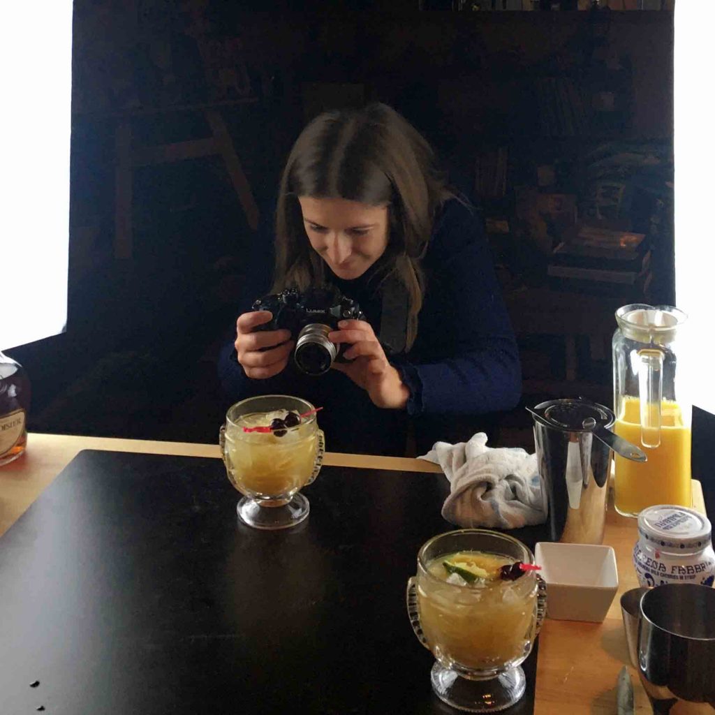 Tiffany Quillan taking a photo of a Roaring Spork drink