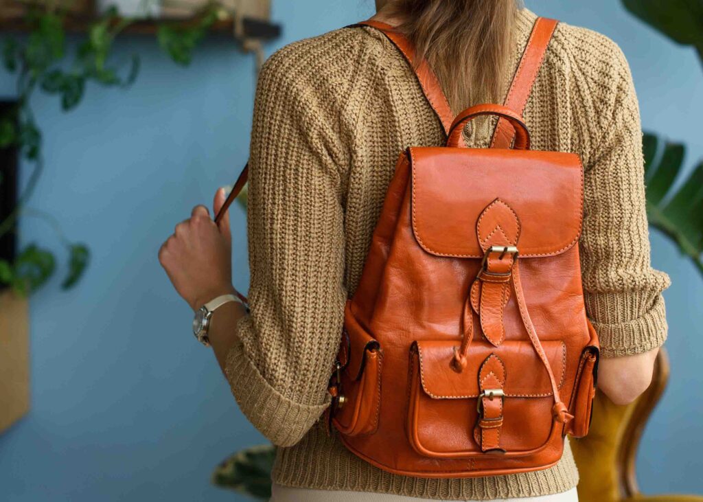 Girl wearing a laptop backpack that is vegan leather